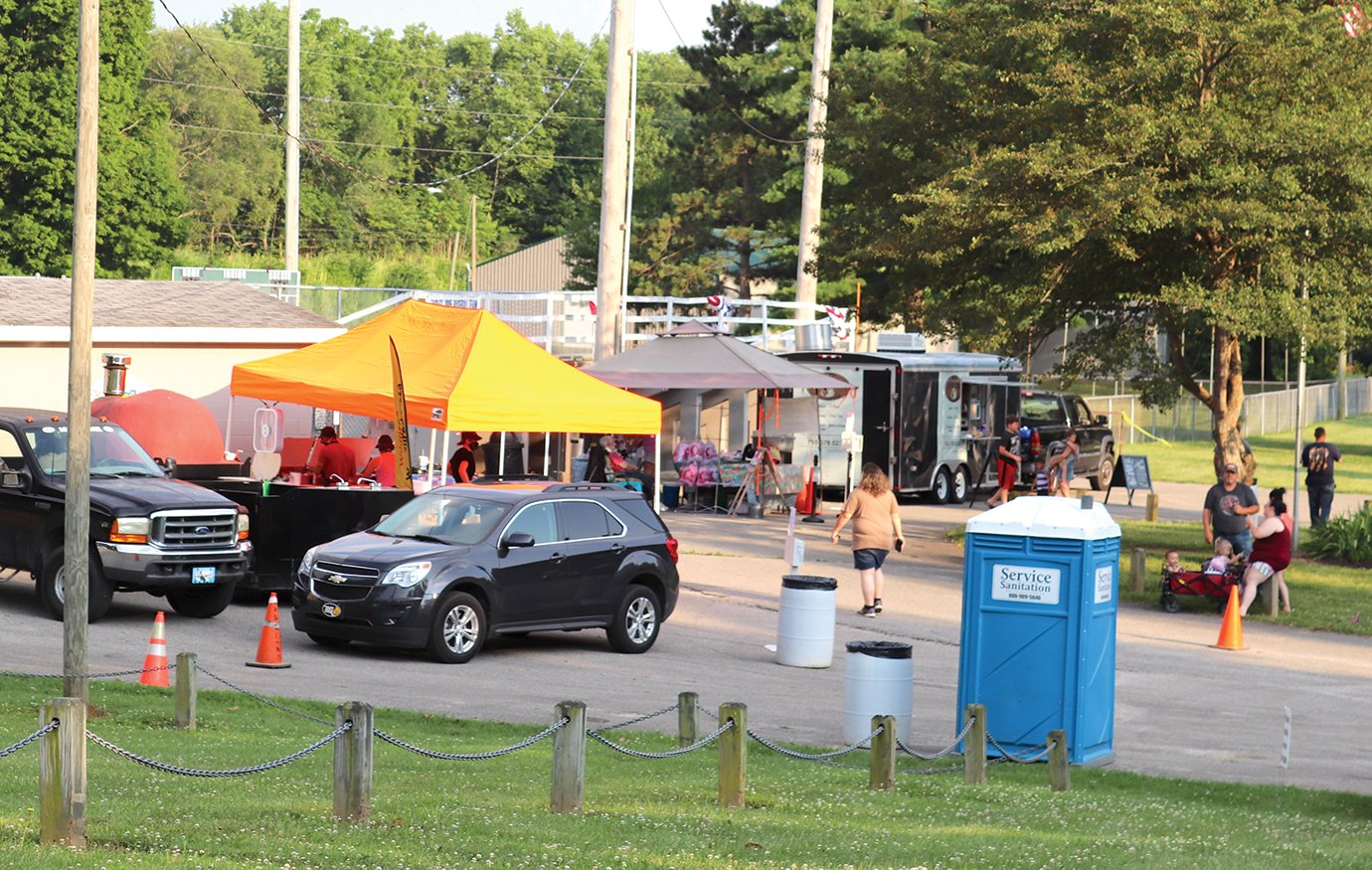 Tents and trailers for Wildfire 348, from left, Cotton Candy Annie and 1832 Brew line the bleacher section of Baldwin Memorial Field on Saturday ahead of the annual fireworks display at Milligan Park.